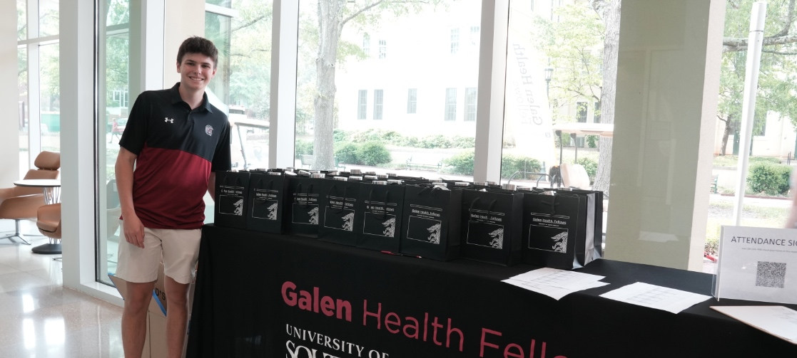 student at welcome table