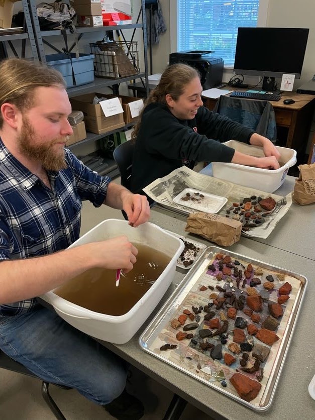 Students cleaning artifacts