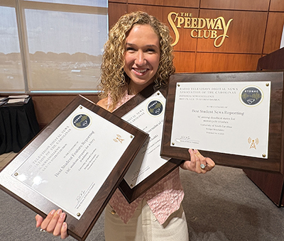Bridget Bruchalski holding her three first place awards