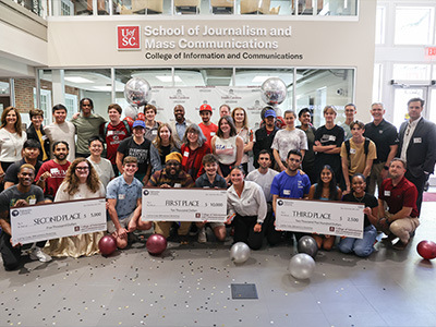 Students display winning checks after the WatsonX competition