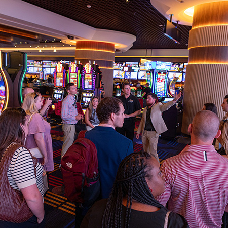 Students listen to a casino representative while touring Las Vegas.