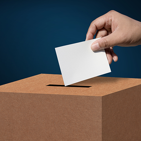 Hand placing envelope in box