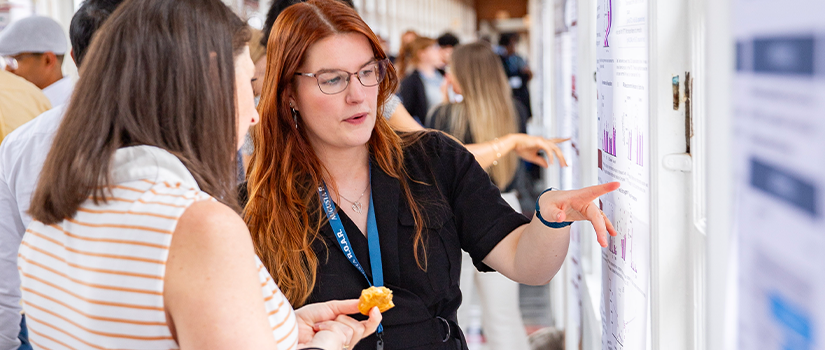 Student presenting research to a professor