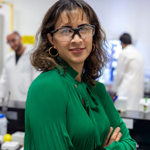 woman wearing safety goggles stands in a lab
