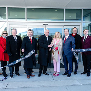University and South Carolina leadership cut a “USC Brain Health” ribbon outside the Brain Health Center, flanked by garnet, black and white balloons.