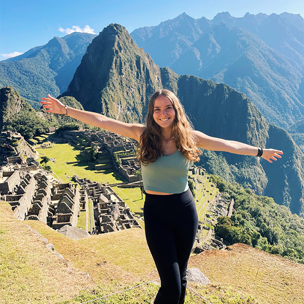 Kayla Davenport poses with her arms outstretched on a study abroad trip to Peru.